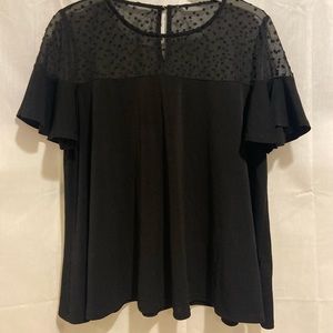 Black top with a mesh polkadot top portion